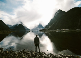 Man looking at lakes and mountains