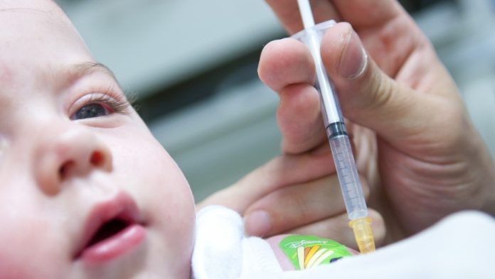Baby receiving a needle