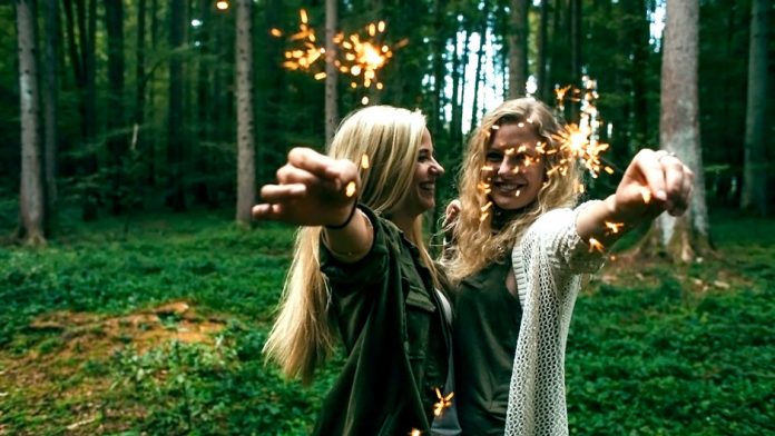 Two girls holding sparklers