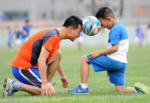 Man and boy playing soccer
