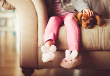 Child with dog on sofa