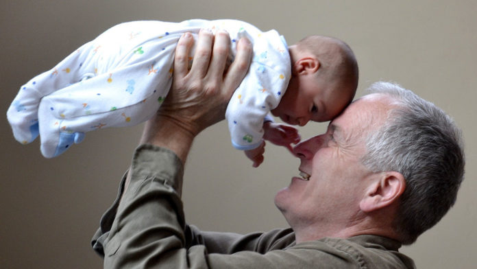 Grandfather holding baby