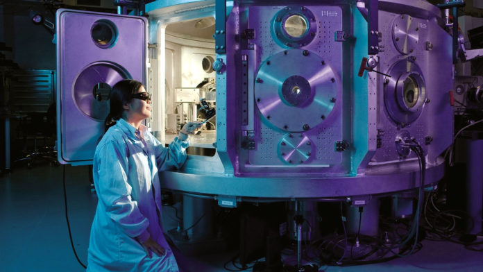 Female scientist working with a machine