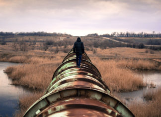 Person walking on oil pipeline