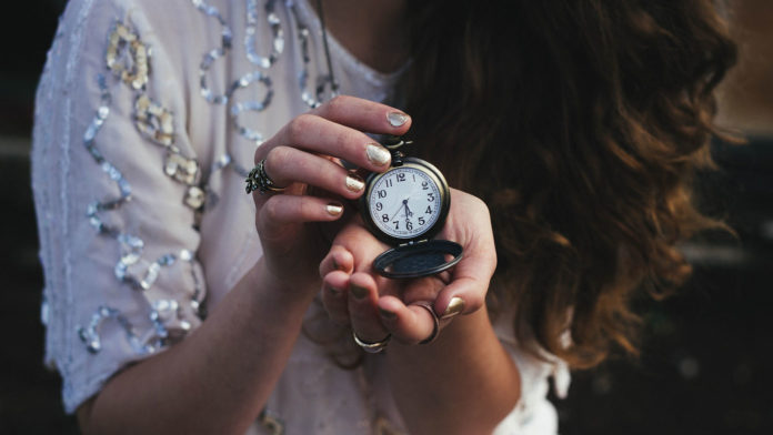 woman holding pocketwatch
