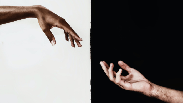 Black and white hands, on a black and white background.