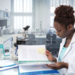 african-american-scientist-reading-laboratory-journal-research-facility_87646-392